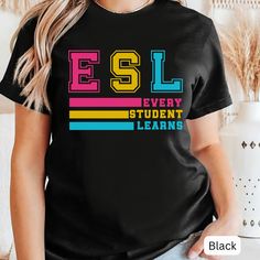 🖤ESL Teacher Shirt🖤 This cute ESL teacher shirt is perfect for the first day of school! It's a thoughtful and stylish gift that any ESL teacher will love, making them feel special and ready to inspire their students.  🛒 How to Order: 1. Check Photos: Review sizing and color options. 2. Select Options: Choose quantity, size, and color from the drop-down menus. 3. Add to Cart: Add each shirt to your cart individually 4. Combined Shipping: Shipping will automatically combine for multiple shirts Casual Name Print T-shirt For Back To School, Black Text Print Top For Back To School, Black Text Print T-shirt For School, Black T-shirt With Heat Transfer Vinyl For School, Casual T-shirt With Name Print For School, Casual School T-shirt With Name Print, Casual Black Tops For Back To School, Casual Black Top For Back To School, Multicolor Letter Print T-shirt For College