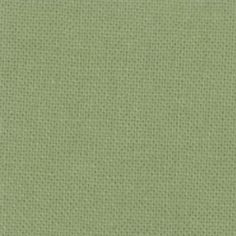 a light green fabric textured with small dots on the top and bottom, as well as an area for text