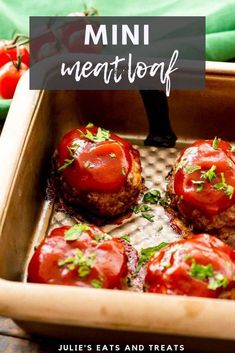 mini meatloaf with tomatoes and parsley in a baking pan on a wooden table