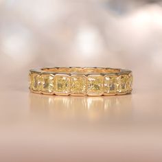 This impressive diamond band is made in 18k yellow gold with an eternity of fancy yellow diamonds. The diamonds weigh a total of approximately 5.16 carats with VS clarity. ✦ DIAMOND SPECIFICATIONS: Diamond Cut: Cushion Cut Diamond Weight 5.16 Carats Total ✦ ENGAGEMENT RING SPECIFICATIONS: Ring Material: Yellow Gold Stones: Diamond ✦ WHAT COMES IN YOUR SHIPMENT: - Your Engagement Ring - Quality Ring Box - Jewelry Cleaner - UGL Certificate ✦ WHY SHOP WITH US: - We've been in business for 40+ years Yellow Diamond Band Ring, Yellow Diamond Eternity Band, Yellow Diamond Band, Yellow Diamond Wedding Band, Estate Diamond Jewelry, Diamond Eternity Wedding Band, Half Bezel, Yellow Diamond Rings, Fancy Yellow Diamond