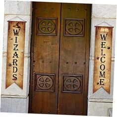 two wooden doors with welcome signs on them