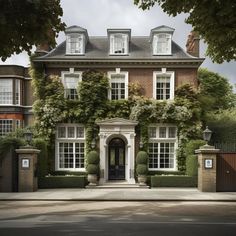 a large brick house with ivy growing all over it's sides and windows on the front