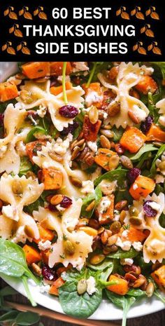 a white plate topped with pasta salad and nuts on top of green leafy leaves