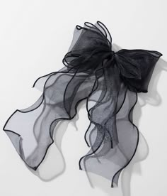 a black and white scarf on a white surface