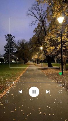 an image of a street at night with trees and lights in the background, which are connected to different devices