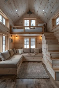 a living room with wooden walls and stairs