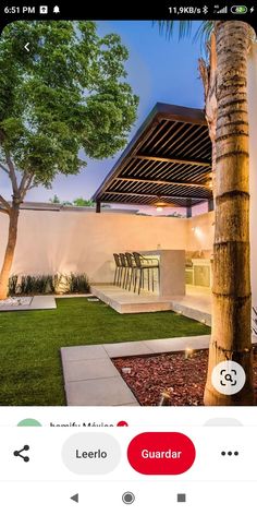 an iphone photo of a house with landscaping and trees in the foreground, next to a palm tree