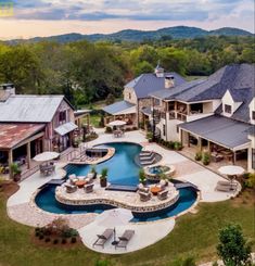 an aerial view of a large home with a pool and patio in the foreground