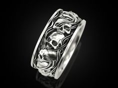 a silver ring with two skulls on it