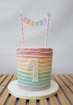 a multi - colored birthday cake with the number one on it