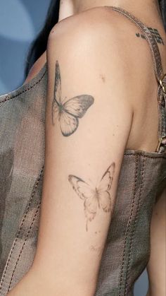 a woman with a butterfly tattoo on her arm