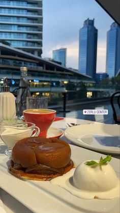 a plate with some food on top of it next to a cup and saucer