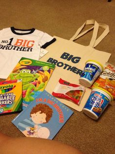 children's books and t - shirts are laid out on the floor next to a bag