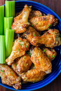 chicken wings and celery on a blue plate