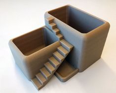 there are two cups that have steps in them on the table, one is made out of cardboard