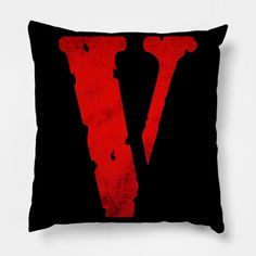 a black and red pillow with the letter v on it