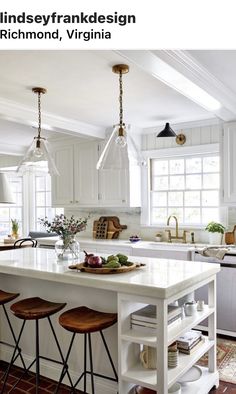 a kitchen island with stools in front of it