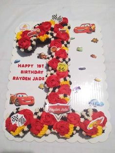 a birthday cake with cars and flowers on it's number 1, made to look like the number one