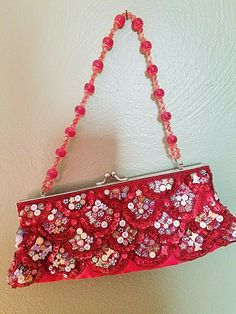 Unbranded: Dressy party Clutch!  Hand-beaded sequins, alphabet beads, flowers, and butterflies, on a red satin fabric make this unique.  This has a silver metal snap closure.  The interior lined in red satin.  The handle is made of red and white beaded balls.  Very clean with NO rips, tears, or stains.   Measurements:  11" wide across bottom                               2-1/2" deep                                4-1/2" tall (clutch only)  x 11" tall (to the top of the handle) Red Embellished Clutch For Formal Occasions, Red Beaded Evening Bag For Party, Red Beaded Clutch For Party, Red Beaded Clutch Evening Bag, Red Embellished Evening Bag For Festive Occasions, Red Beaded Rectangular Clutch, Beaded Red Rectangular Clutch, Red Sequined Party Bags, Festive Red Embellished Evening Bag