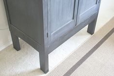 a bathroom vanity with two drawers and a rug on the floor in front of it