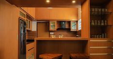 a kitchen with wooden cabinets and stools