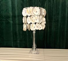 a lamp made out of seashells on a table