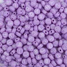 purple beads with white letters on them