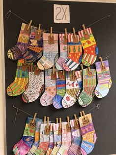 there are many pairs of socks hanging on the clothesline with numbers attached to them