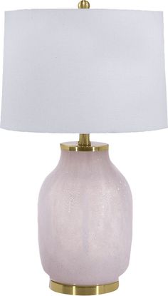 a white lamp with a gold base and a white shade on the top of it