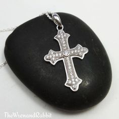 "Sterling Cross necklace - cross pendant - cubic zirconia - religious jewelry - silver cross - Christian - Catholic - gothic cross - tween ---------------- Beautiful genuine solid sterling silver Cross with set cubic zirconia gems - approx 1\" long not incl. bail, note that mannequin is not life size. - choose your length of sterling silver chain Makes a nice gift for a christening or confirmation For more affordable sterling silver jewelry: www.etsy.com/shop/thewrenandrabbit For Buddha, Yoga, H Wing Jewelry, Precious Gemstones Jewelry, Symbolic Jewelry, Garnet Earrings, Coin Jewelry, Celtic Jewelry, Sterling Silver Cross, Religious Jewelry, Silver Cross