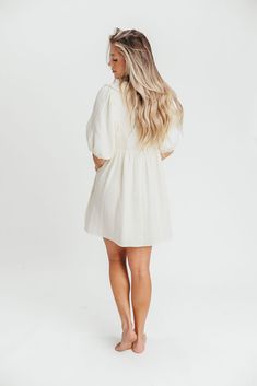 The feeling of cool, crisp cotton against your skin will keep you reaching for this gorgeous mini dress over and over as the temps rise. Featuring a beautifully tailored collared neckline and 1/2 length balloon sleeves, the Tiffany dress is crafted from a luxuriously soft 100% cotton gauze. Pair this beauty with everything from sandals to pumps to Sambas - there's no bad styling with the Tiffany dress. FIT: Runs true to size - relaxed fit. MATERIAL: 100% Cotton. GARMENT DETAILS: Lightweight summ Cotton Mini Dress With Balloon Sleeves, Cream Puff Sleeve Mini Dress, Feminine Cream Mini Dress With Puff Sleeves, Chic Cotton Puff Sleeve Shirt Dress, Chic Cotton Shirt Dress With Puff Sleeves, Chic Cream Puff Sleeve Mini Dress, Chic Cream Mini Dress With Puff Sleeves, Feminine Collared Mini Dress For Daywear, Chic Linen Puff Sleeve Dress