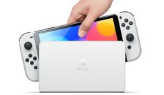 a nintendo switch is being held up by someone's hand