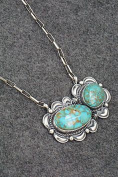 This stunning natural Kingman turquoise and sterling silver necklace was made by Navajo silversmith Raymond Delgarito. The back is signed RD and stamped sterling.Necklace: 20" with additional 3 1/2" extender chainPendant Length: 1 3/8"Pendant Width: 2 3/4"Free shipping on all orders! We ship with USPS and always include tracking. All orders ship within a day of payment.Returns are accepted up to 30 days after you receive your order. Just send us a message. Our shop offers cash back or store cred Western Sterling Silver Turquoise Pendant Necklace, Western-style Sterling Silver Turquoise Pendant Necklace, Western Style Turquoise Pendant Necklace In Sterling Silver, Southwestern Sterling Silver Turquoise Necklace, Western Style Necklace With Large Sterling Silver Pendant, Western Style Collectible Turquoise Sterling Silver Necklace, Southwestern Sterling Silver Turquoise Necklace With Large Pendant, Southwestern Sterling Silver Turquoise Necklace Collectible, Southwestern Turquoise Sterling Silver Collectible Necklace