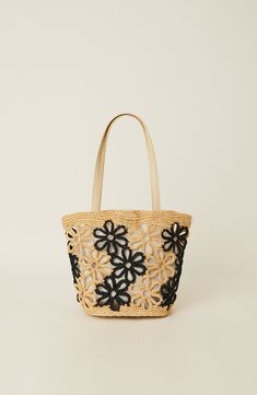 Crafted with care and adorned with woven straw flowers, our Mahi Floral Tote embodies the essence of the season with its charming design and versatility. Made from high-quality straw material, this clutch exudes elegance and sophistication, making it the perfect companion for all your springtime adventures. Unlined. *Please note this item is a final sale item Dimensions: H9.25"xW12.5"xD6" Spring Shopping Black Crochet Bag, Black Crochet Bag For Shopping In Spring, Black Crochet Bag For Spring Shopping, Elegant Spring Straw Shopping Bag, Elegant Crochet Bag For Spring, Elegant Jute Crochet Bag For Spring, Chic Black Crochet Bag For Spring, Elegant Crochet Jute Bag For Spring, Spring Crochet Jute Bag With Woven Leather