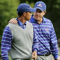 two men standing next to each other wearing blue and white striped shirts, one with his arm around the other's shoulder