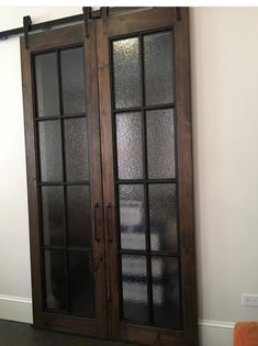 two glass doors in the corner of a room