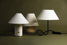 three lamps sitting next to each other on a table