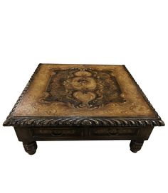 an ornately decorated coffee table with two drawers on one side and a decorative design on the other