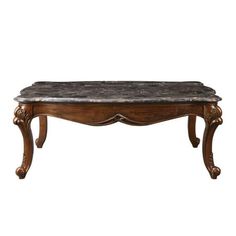 an old wooden table with marble top