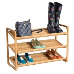 a bamboo shoe rack with two pairs of shoes and a handbag on the bottom shelf