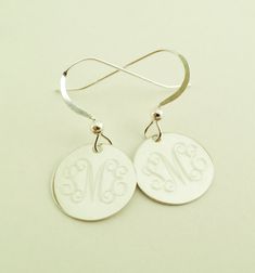 "Dangle Earrings in Sterling Silver Perfect present for Valentines Day or any occasion. Sterling silver dangle earrings will be monogrammed engraved permanently. Top quality 925 sterling silver. Comes gift boxed. Please state engraving information in notes to seller at checkout. Shown with Interlocking monogram, single initials also look very good on these. You can see font choices in extra photos. For Monograms please provide initials in first, last, middle order. Earrings- 1/2\" Sterling Silve Mother's Day Sterling Silver Drop Earrings, Sterling Silver Drop Earrings For Mother's Day, Sterling Silver Monogram Round Disc Jewelry, Personalized Drop Earrings For Anniversary, Engraved Sterling Silver Drop Earrings, Silver Engraved Round Earrings, Personalized Sterling Silver Earrings As Gift, Engraved Sterling Silver Adjustable Earrings, Elegant Personalized Adjustable Earrings