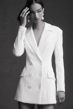 Embodying sleek sophistication and feminine allure, the MISHA Ander Dress captivates with its striking v-neckline and daring mini length, all tailored into a beautifully structured, double-breasted blazer silhouette. | Ander Mini Blazer Dress Jacket by MISHA in White, Women's, Size: XS, Polyester/Elastane at Anthropologie Double Breasted Outfit Women, White Tuxedo Dress Women, Bridal Blazer Dress, Wedding Blazer Women, Tuxedo Dress Outfit, Tuxedo Dress Wedding, Jacket Dresses For Women, Blazer Dress Outfits Classy, White Suit Dress