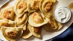 some dumplings are sitting on a white plate