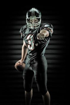 a football player in uniform is posing for the camera with his hand on his hip