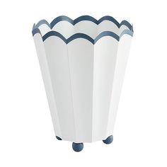 a white and blue vase sitting on top of a table