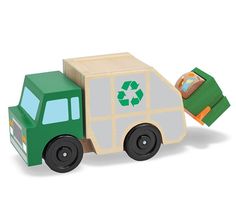 a green toy truck carrying a cardboard box