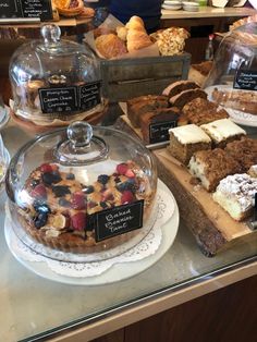 various desserts and pastries on display in a bakery