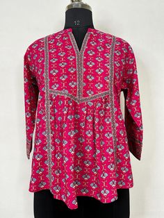 Fuchsia Pink Printed Tunic Top /Kurti For Women Short Kurta For Women- This outfit is made with the finest Pure Cotton of India. The set contains : 1  Kurti Kurti: Fuchsia printed empire top kurti/tunic comes with a mandarin collar neck ,sequinned  details, flared waist and straight hem.  Sleeve length :  3/4 Sleeves   Material : Kurti :  Pure Cotton Fabric Care : Machine wash Front length : 28 inches Please see the photo section  to choose a perfect size for yourself.  *Please note the color of Bohemian Tops With Printed Motifs, Traditional Red Block Print Top, Festive Traditional Tops With Printed Motifs, Casual Pink Kurta For Festive Season, Bohemian Straight Kurta Tops For Navratri, Traditional Floral Print Tunic Top, Bohemian Tops With Festive Motifs, Cotton Block Print V-neck Top, Bohemian Style Festive Tops With Motifs