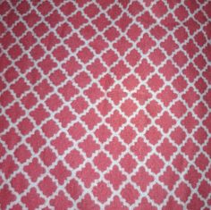 a red and white fabric with an intricate design on it's surface, as well as the background