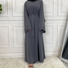 A modest wardrobe essential. Our IMAN dress is a timeless, classic piece. It can be worn beautifully both with or without a belt. This abaya is a loose fit which allows the high quality material to flow elegantly and gracefully. Including: A matching colored belt. Material: High-quality nidha fabric Modest Solid Color Floor-length Abaya, Elegant Belted Abaya, Modest Floor-length Abaya, Grey Abaya, Modest Wardrobe, Abaya Designs, Dark Grey Color, The High, Timeless Classic